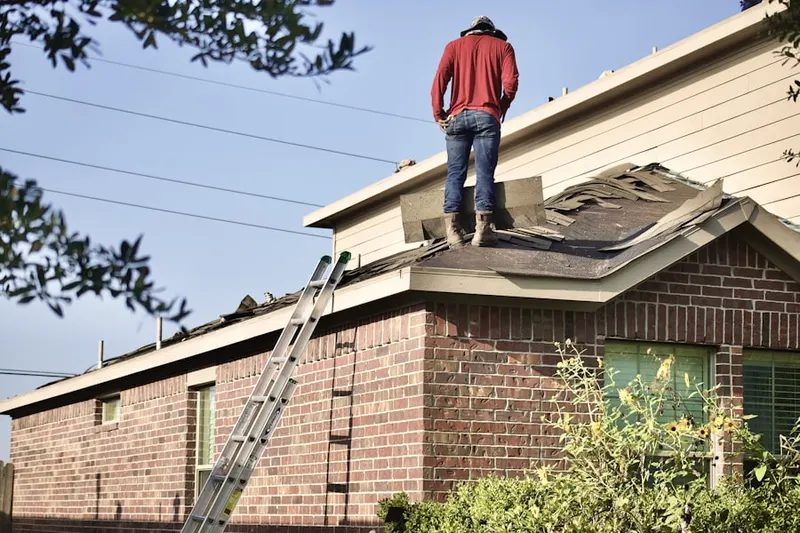 Professional roofer working on a residential roof in Pennington